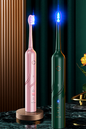PAT10 sonic electric toothbrush in gold, black and silver with blue brush-head lighting